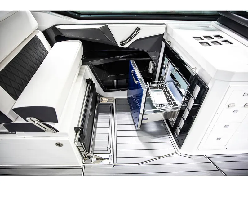 Slide: The Image of 2022 Monterey 38 Super Sport boat interior with open refrigerator and seating area. - 8
