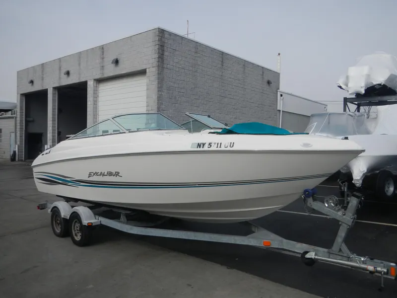 Slide: The Image of 2000 Wellcraft EXCALIBUR boat on a trailer outside a storage facility. - 2