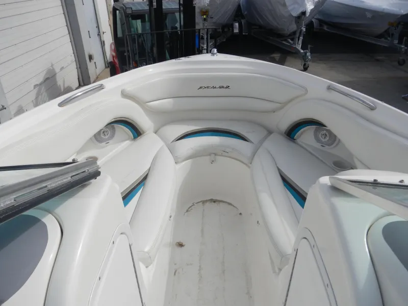 Slide: The Image of Interior of a 2000 Wellcraft EXCALIBUR boat with white seating and blue accents. - 6