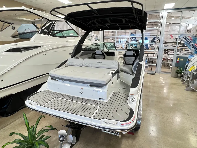 Slide: The Image of 2023 Sea Ray SLX 260 boat in showroom, rear view with seating and swim platform. - 2