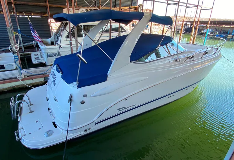 The Image of 2003 Chaparral 280 Signature boat docked with blue canopy and sleek white design. - 0