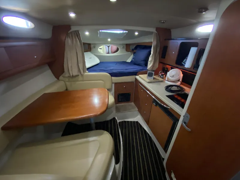 Slide: The Image of Interior of 2003 Chaparral 280 Signature boat with dining area and kitchenette. - 17