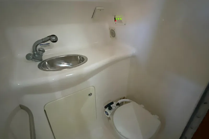 Slide: The Image of 2003 Chaparral 280 Signature boat bathroom with sink and toilet. - 19