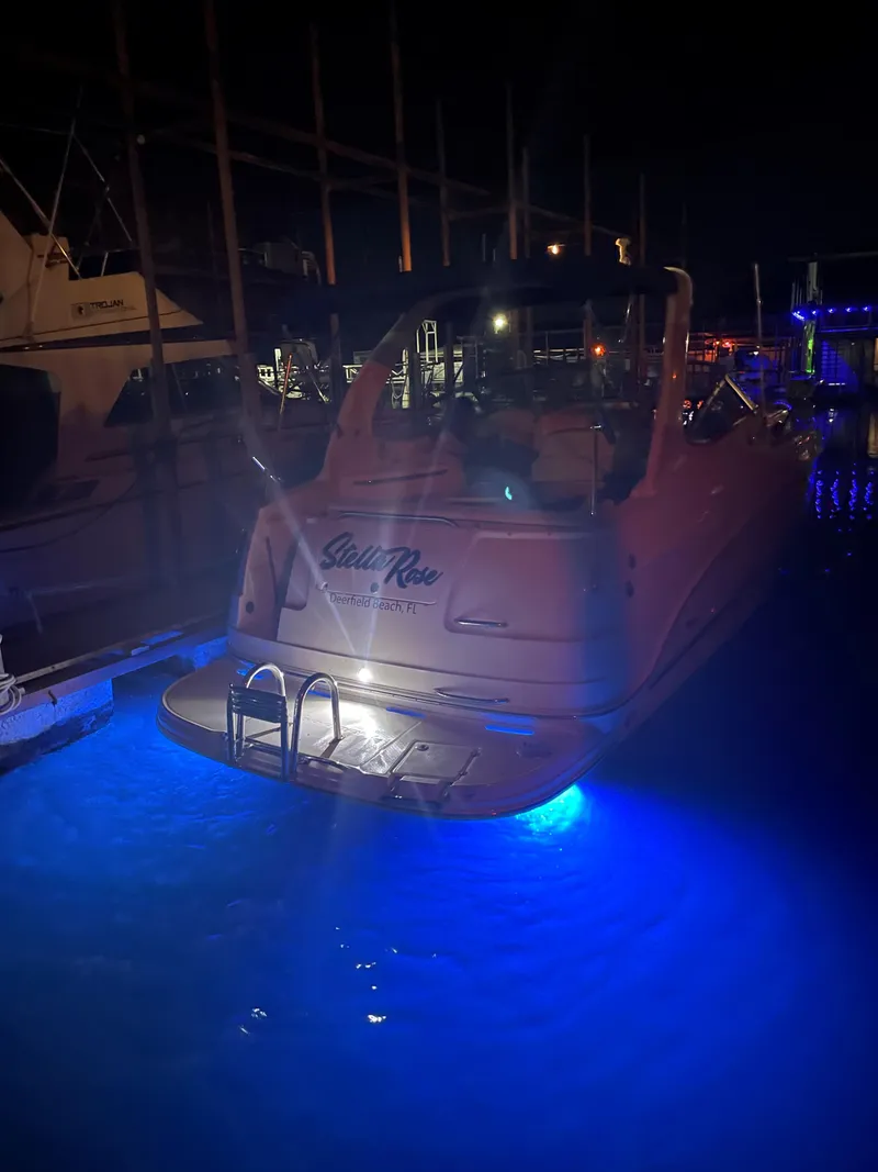 Slide: The Image of 2003 Chaparral 280 Signature boat with blue underwater lights at night. - 6