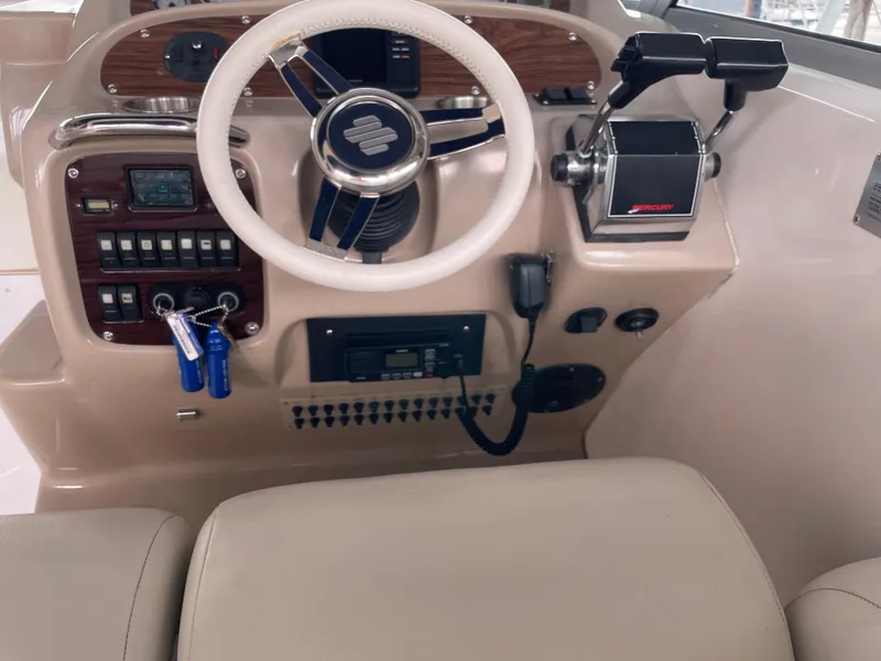 Slide: The Image of 2003 Chaparral 280 Signature boat helm with steering wheel and control panel. - 7