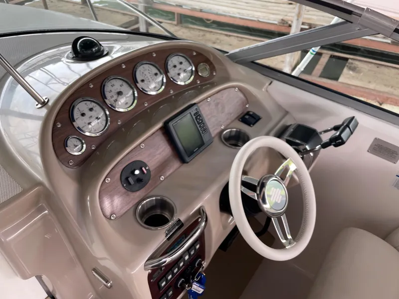 Slide: The Image of Dashboard of 2003 Chaparral 280 Signature boat with gauges and steering wheel. - 8