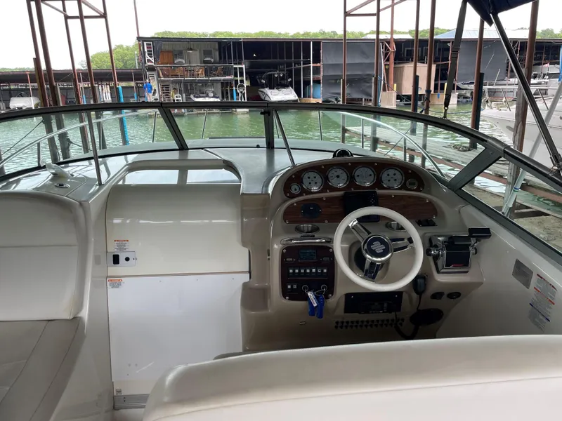 Slide: The Image of 2003 Chaparral 280 Signature boat cockpit with steering wheel and dashboard at marina. - 9