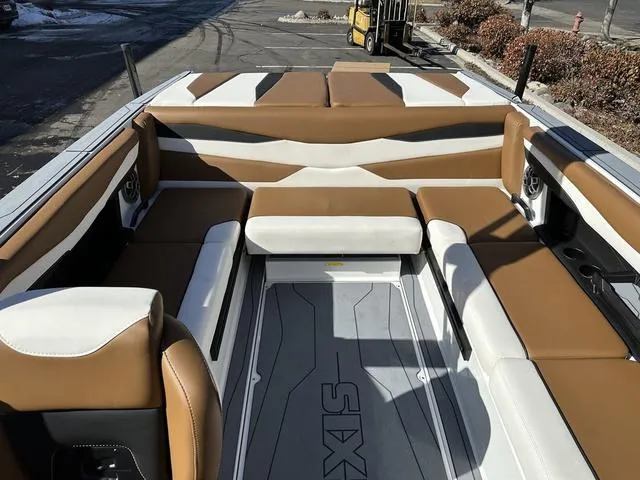 Slide: The Image of 2023 Axis Wake Research A225 boat interior with tan and white seating. - 6