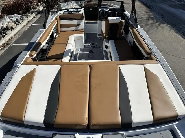 Slide: The Image of 2023 Axis Wake Research A225 boat interior with brown and white seating. - 7