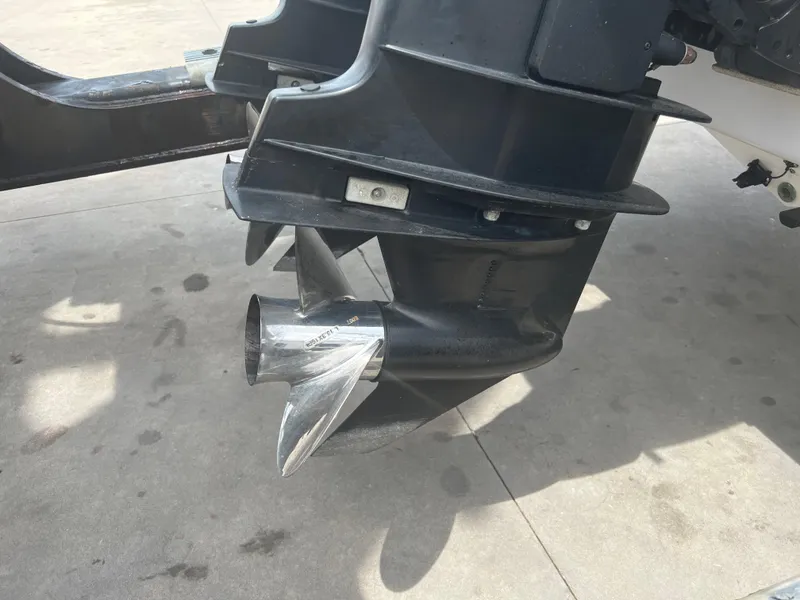 Slide: The Image of Close-up of a 2002 Donzi 29 ZF Cuddy boat propeller on concrete surface. - 22