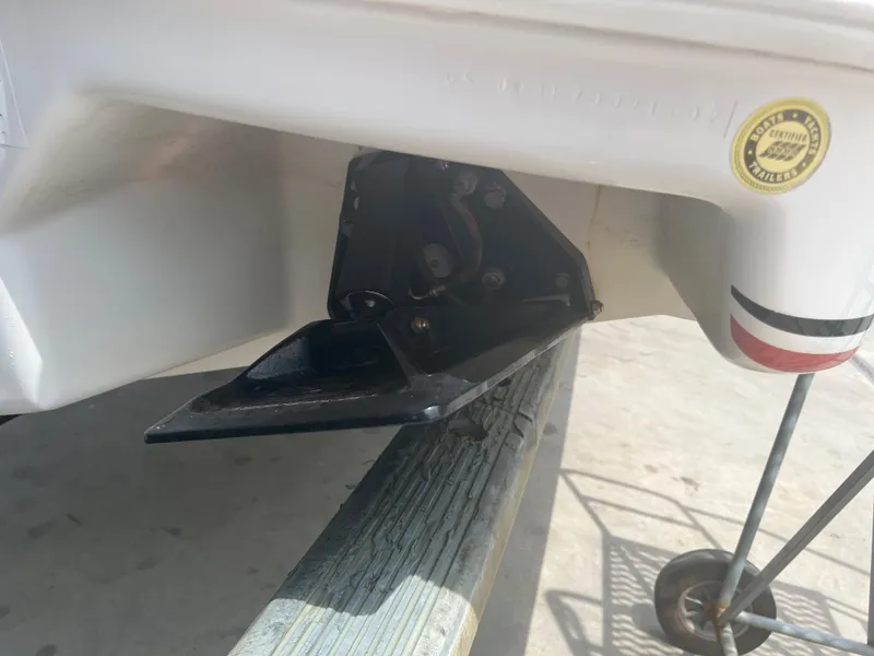 Slide: The Image of 2002 Donzi 29 ZF Cuddy boat detail, showing trim tab and hull. - 23