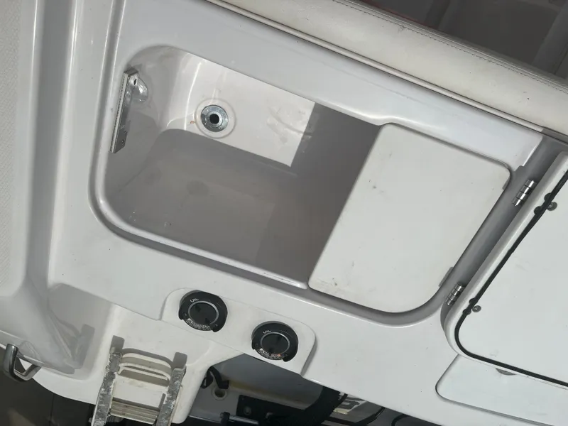 Slide: The Image of 2002 Donzi 29 ZF Cuddy boat storage compartment with controls and ladder. - 25