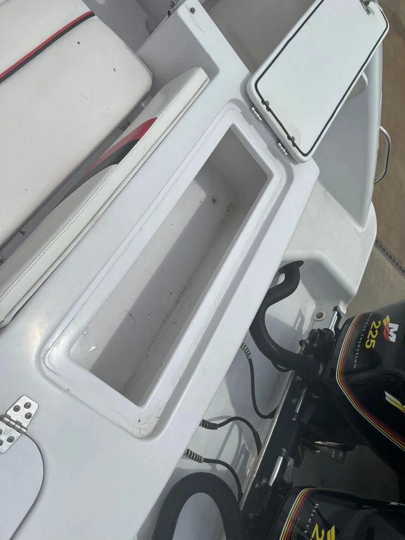 Slide: The Image of 2002 Donzi 29 ZF Cuddy boat interior with storage compartment and twin Mercury engines. - 26