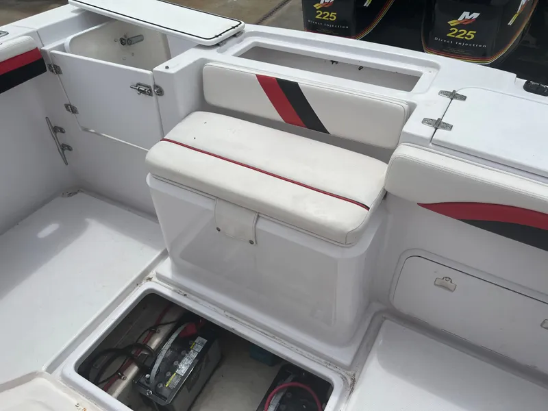 Slide: The Image of 2002 Donzi 29 ZF Cuddy boat interior with seating and storage compartments. - 27