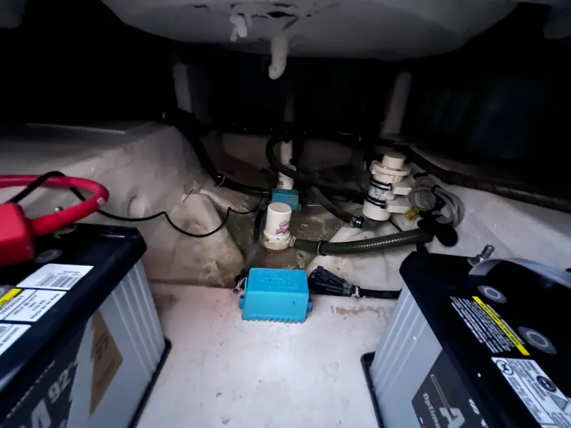 Slide: The Image of 2002 Donzi 29 ZF Cuddy boat battery compartment with wiring and components. - 33