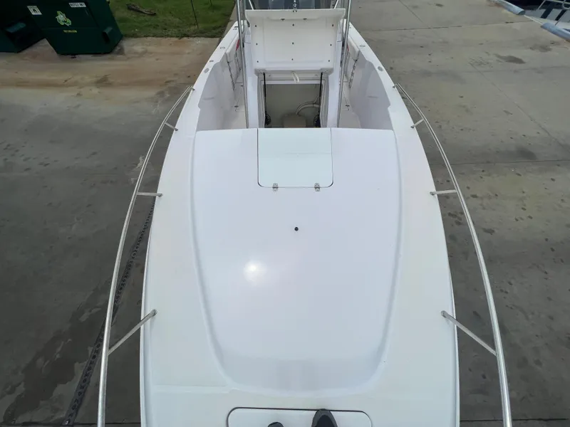 Slide: The Image of 2002 Donzi 29 ZF Cuddy boat deck, white exterior, docked on concrete. - 44