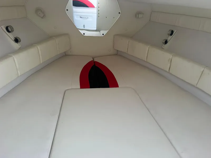 Slide: The Image of Interior cabin of a 2002 Donzi 29 ZF Cuddy boat with white cushioned seating. - 47