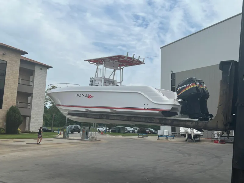 Slide: The Image of 2002 Donzi 29 ZF Cuddy boat on forklift, outdoor storage area. - 5