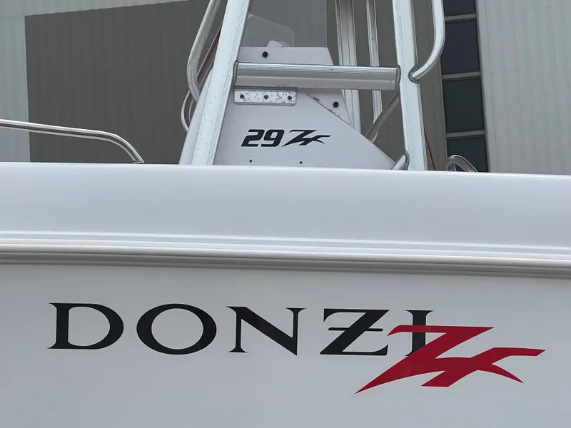 Slide: The Image of 2002 Donzi 29 ZF Cuddy boat with logo and railing detail. - 9