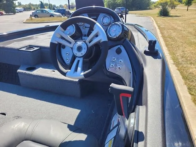Slide: The Image of 2023 Tracker Pro Team 195 TXW Tournament Edition boat interior with carpeted steps and cup holders. - 2