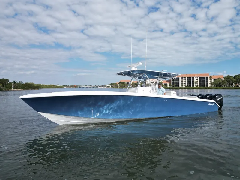 Slide: The Image of 2013 Bahama Open Fisherman boat on calm water with a blue sky background. - 14