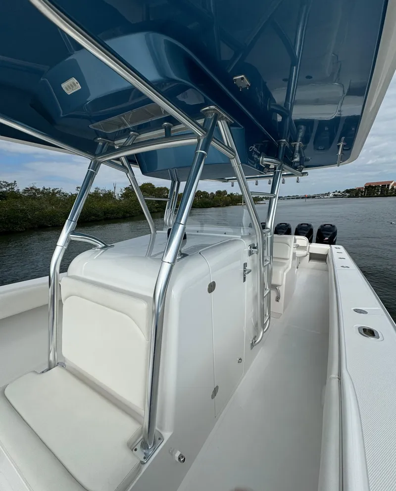 Slide: The Image of 2013 Bahama Open Fisherman boat with blue T-top and white seating. - 17