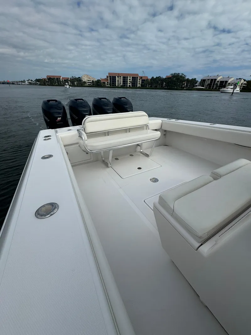 Slide: The Image of 2013 Bahama Open Fisherman boat with multiple outboard engines on a calm waterway. - 19