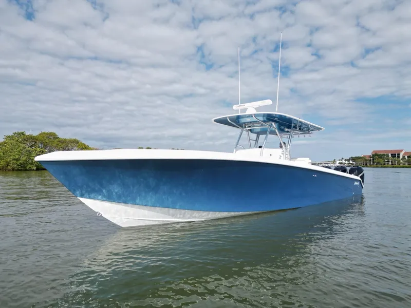 Slide: The Image of 2013 Bahama Open Fisherman boat on calm water under a cloudy sky. - 3