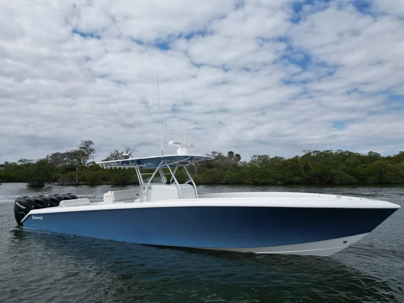 Slide: The Image of 2013 Bahama Open Fisherman boat on calm water with cloudy sky background. - 5