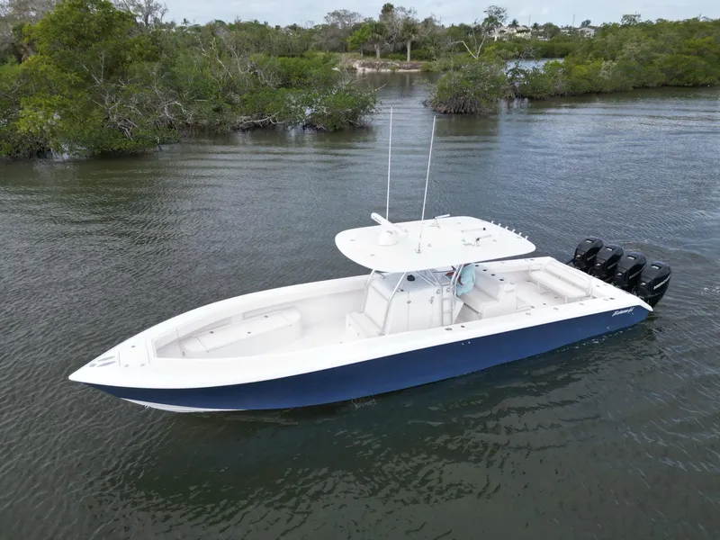 Slide: The Image of 2013 Bahama Open Fisherman boat with triple outboard engines on calm water. - 8