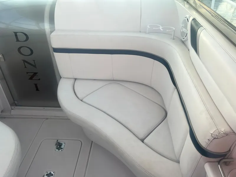 Slide: The Image of 2008 Donzi 38 ZSF boat interior with white cushioned seating. - 22