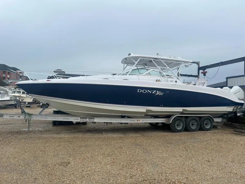 Slide: The Image of 2008 Donzi 38 ZSF boat on a trailer in a marina. - 6