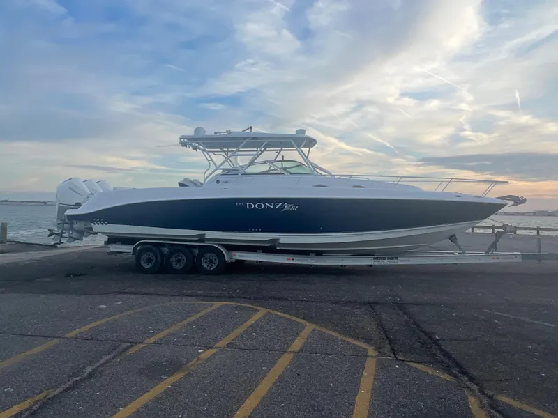 Slide: The Image of 2008 Donzi 38 ZSF boat on a trailer by the waterfront at sunset. - 11