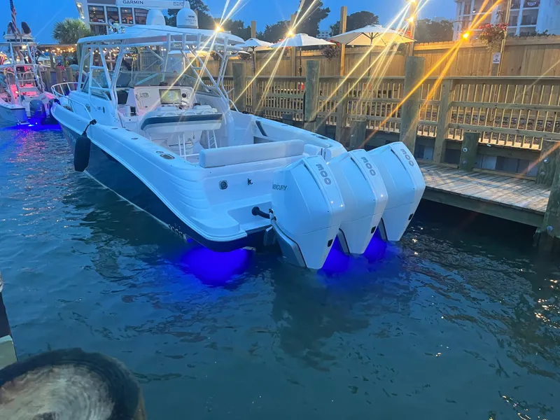 Slide: The Image of 2008 Donzi 38 ZSF boat docked with blue underwater lights at dusk. - 2