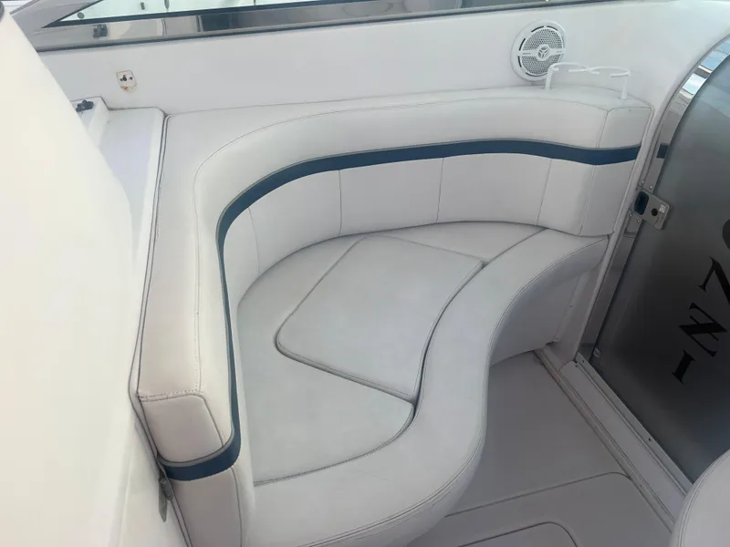 Slide: The Image of 2008 Donzi 38 ZSF boat interior seating with white and blue upholstery. - 21