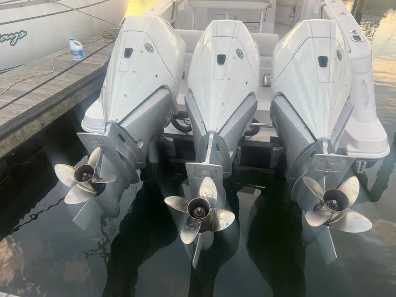 Slide: The Image of 2008 Donzi 38 ZSF boat with triple outboard engines docked. - 4