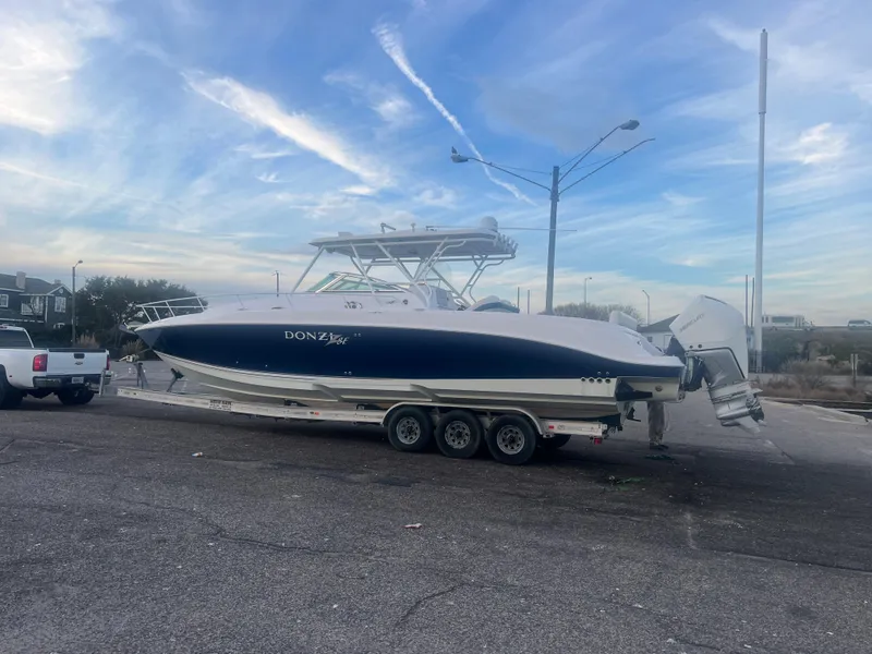 Slide: The Image of 2008 Donzi 38 ZSF boat on a trailer under a blue sky. - 8