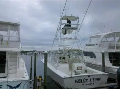 Slide: The Image of 2002 Jersey 36 Express boat "Kelly Lynn" docked at marina under cloudy sky. - 12