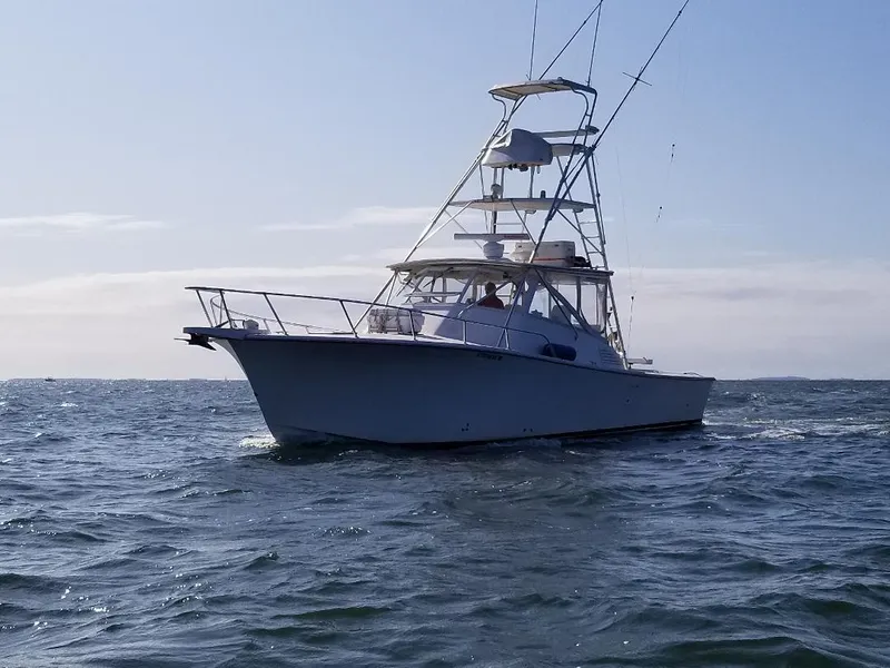 Slide: The Image of 2002 Jersey 36 Express boat cruising on open water. - 14