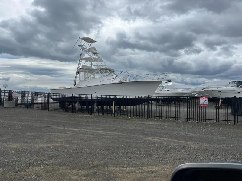 Slide: The Image of 2002 Jersey 36 Express boat on dry dock under cloudy skies. - 15