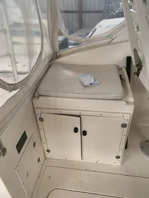 Slide: The Image of 2002 Jersey 36 Express boat interior with storage cabinet and cushioned seat. - 17