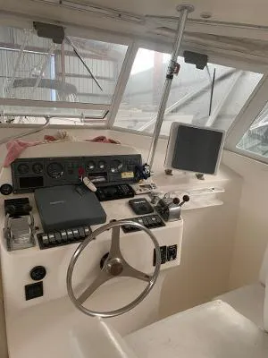 Slide: The Image of 2002 Jersey 36 Express boat helm with steering wheel, gauges, and navigation equipment. - 18