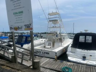 Slide: The Image of Boats docked at marina, featuring a 2002 Jersey 36 Express named Kelly Lynn. - 2