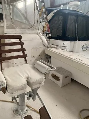 Slide: The Image of 2002 Jersey 36 Express boat interior with captain's chair and cockpit area. - 21