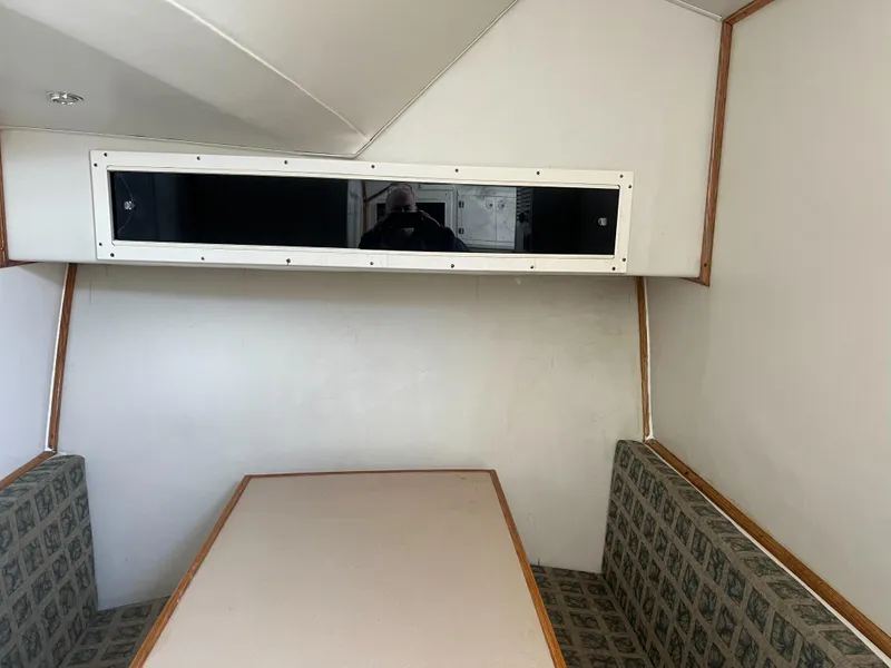 Slide: The Image of Interior dining area of 2002 Jersey 36 Express boat with cushioned seating. - 23