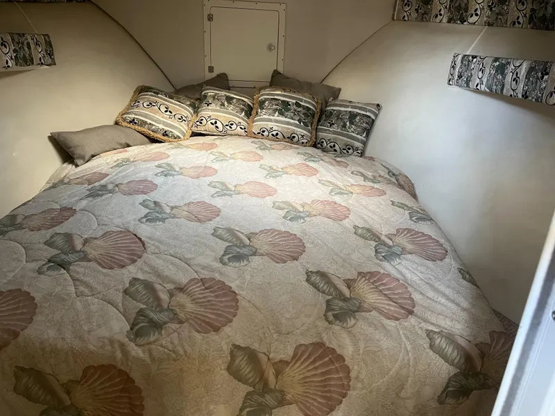 Slide: The Image of 2002 Jersey 36 Express boat cabin with floral bedding and decorative pillows. - 25