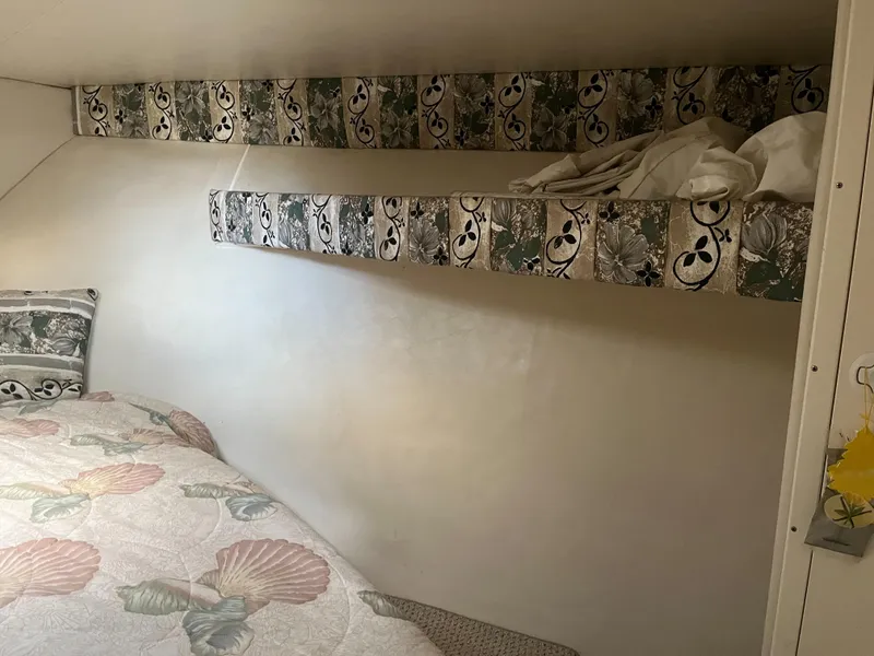 Slide: The Image of Interior of a 2002 Jersey 36 Express boat with bed and storage shelf. - 26