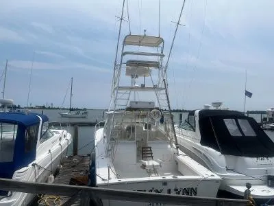 Slide: The Image of 2002 Jersey 36 Express boat docked at marina with other boats. - 3