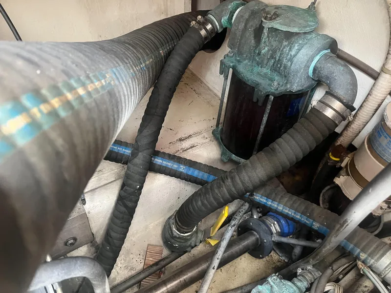 Slide: The Image of Engine compartment of a 2002 Jersey 36 Express boat with hoses and filters. - 39