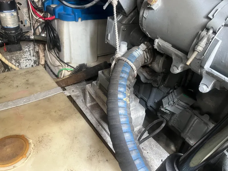 Slide: The Image of Engine compartment of a 2002 Jersey 36 Express boat showing hoses and mechanical components. - 41